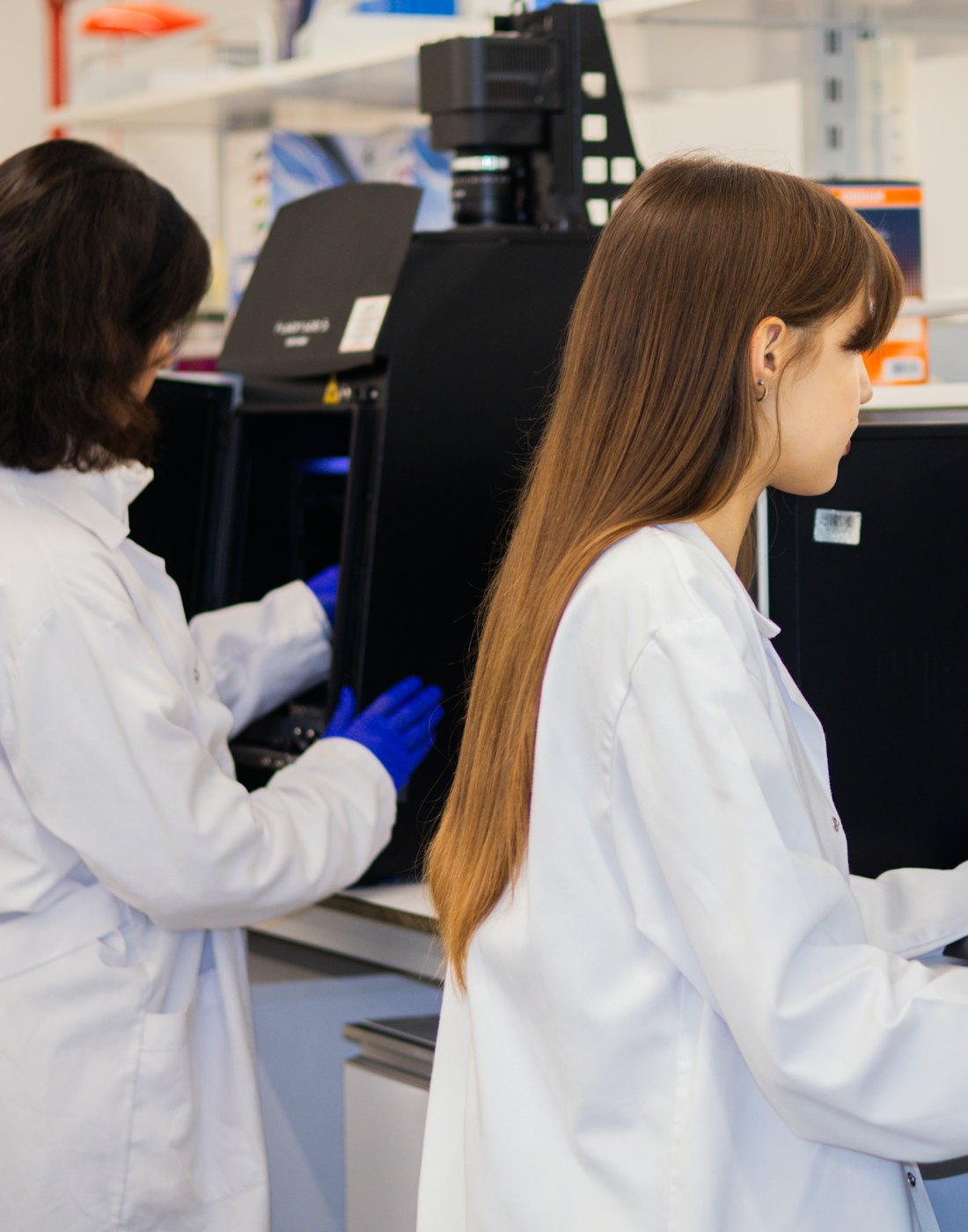 A small team at a workbench in a research lab.